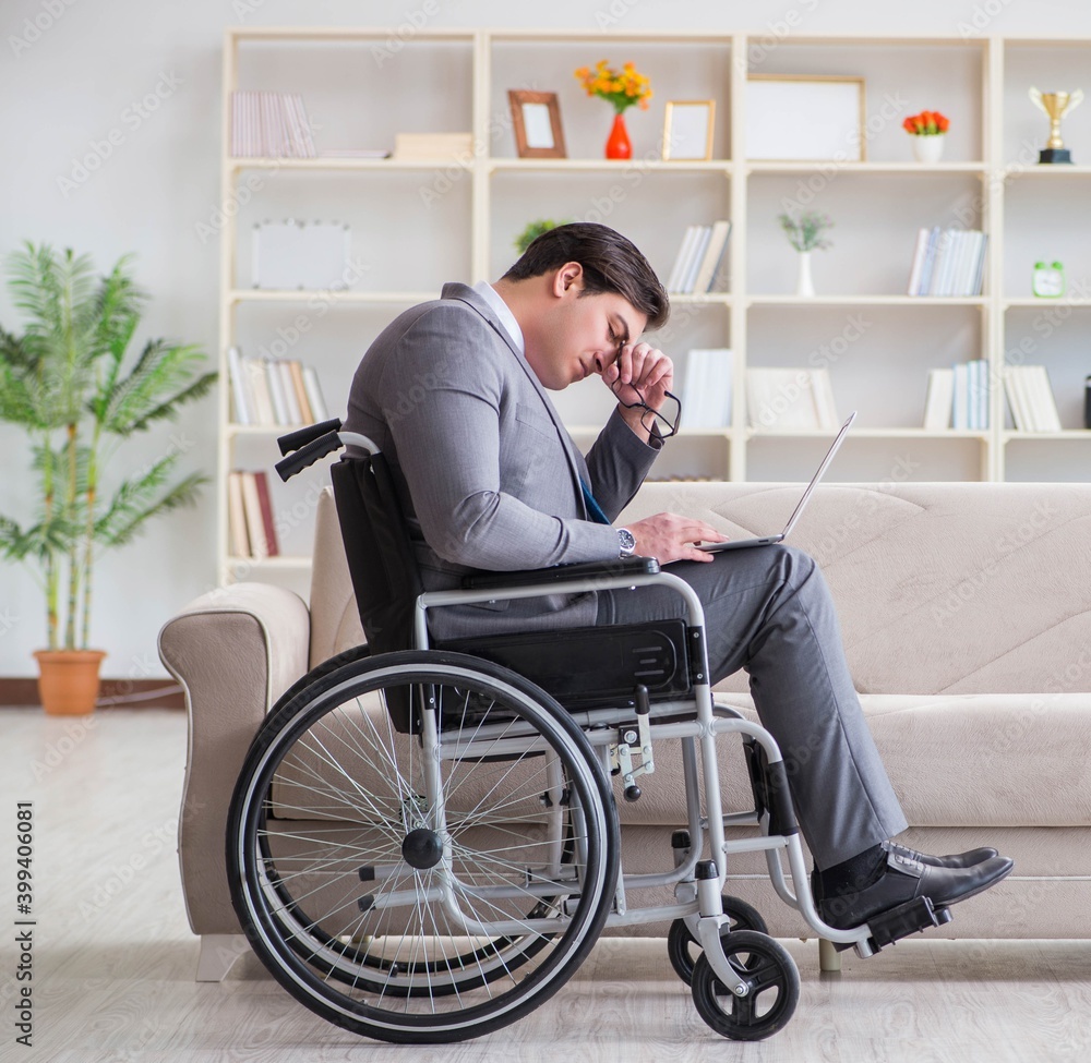 Dsabled businessman on wheelchair working home Dsabled businessman on wheelchair working home