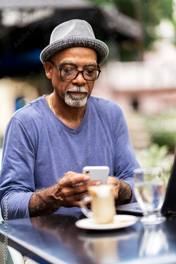 Senior black man using mobile phone. Senior black man using mobile phone.