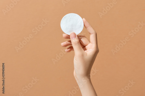 Woman's hand holding clean cotton pad
