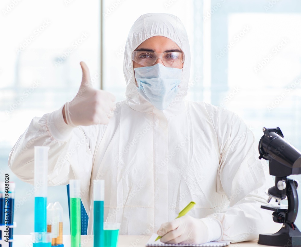 Young chemist student working in lab on chemicals Young chemist student working in lab on chemicals