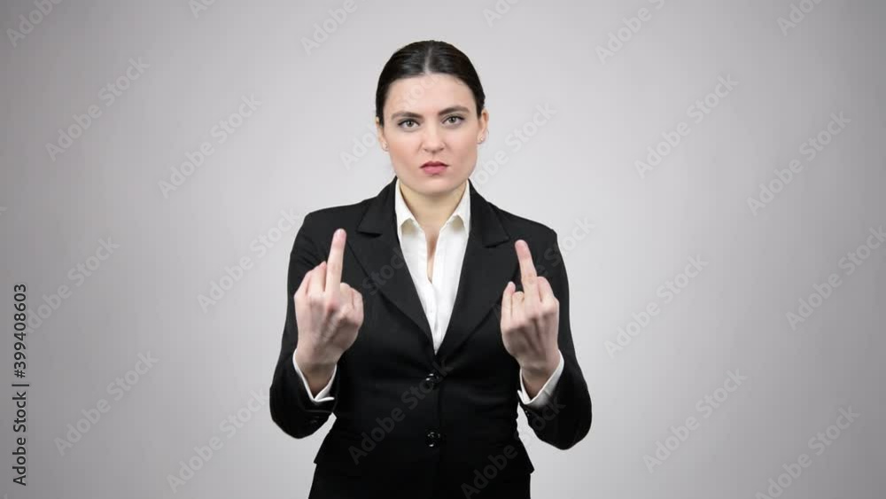 Beautiful business woman showing you a double obscene gesture and wearing a black suit Beautiful business woman showing you a double obscene gesture and wearing a black suit