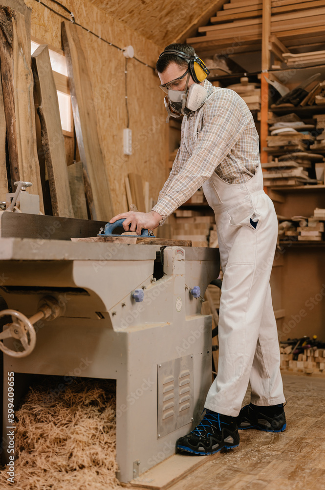 Carpenter using jointer planer in Stock Photo Adobe Stock