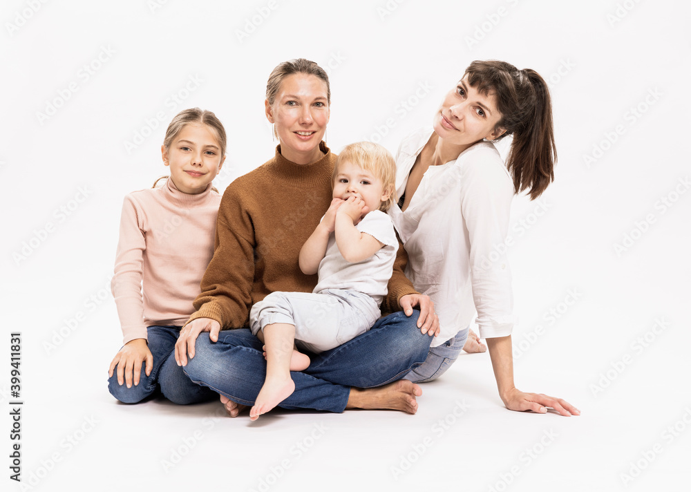 Family sitting together against white background in studio Family sitting together against white background in studio