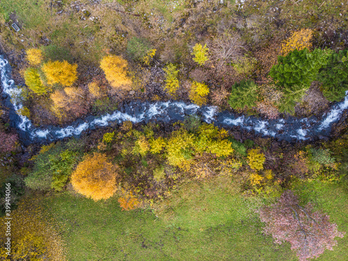 Aerial view of mountain river flowing betwwen forest trees, Champery, Switzerland. photo