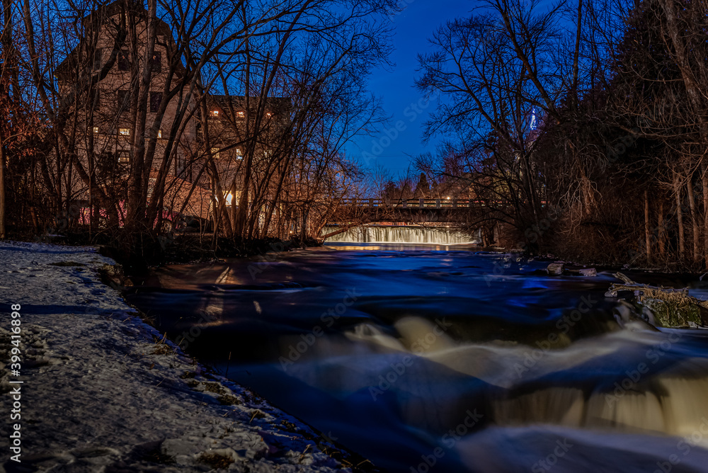 Cedarburg, WI  USA - December 14, 2020: The old mill and dam in Cedarburg Wisconsin decorated for the holidays