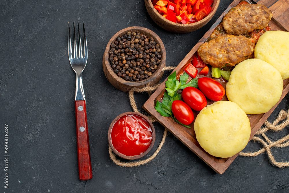 Horizontal view of tasty cutlets chopped vegetables greens for dinner on dark background Horizontal view of tasty cutlets chopped vegetables greens for dinner on dark background