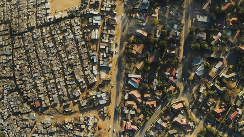 Inequality.Aerial straight down view of an informal settlement Kya Sands squatter camp right next to middle class suburban housing, Gauteng Province, South Africa photo