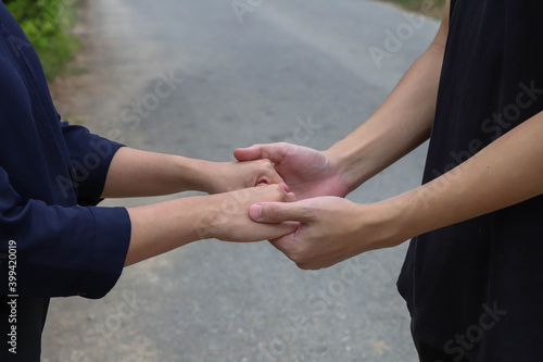 A couple standing with hands showing their concern for each other