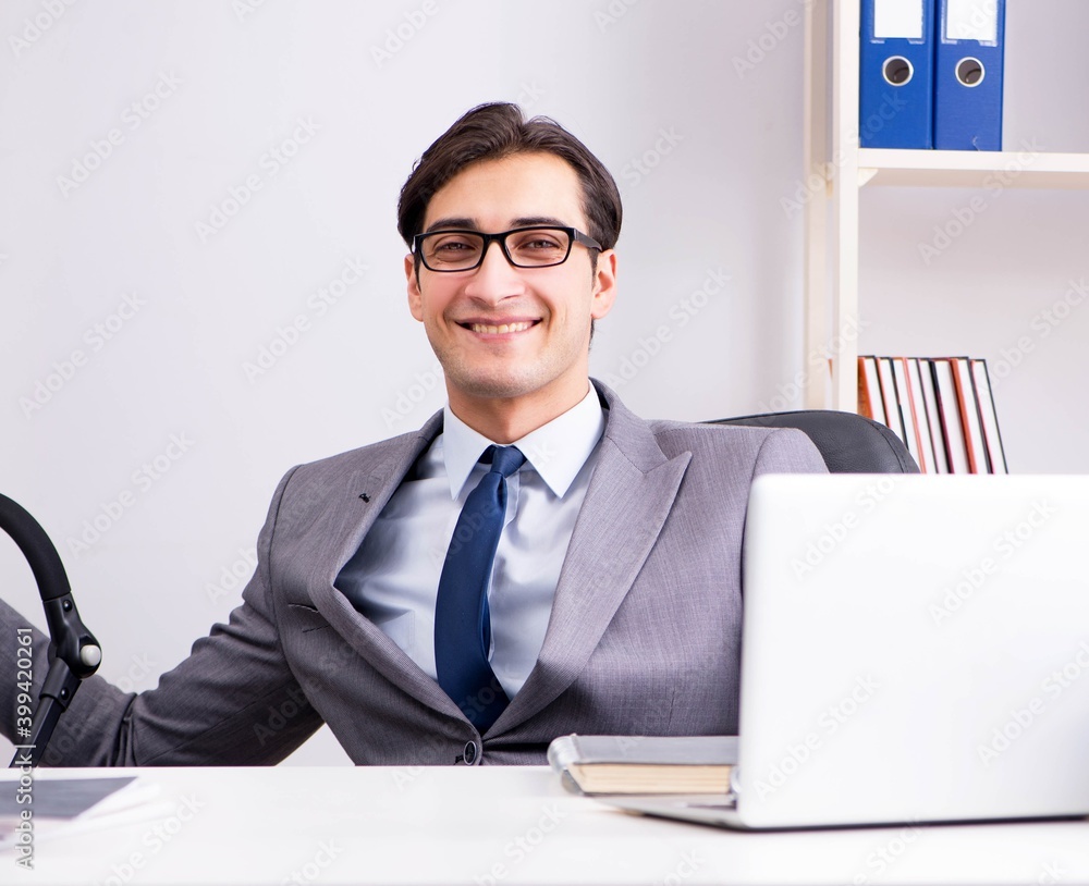 Businessman looking after newborn baby in office Businessman looking after newborn baby in office