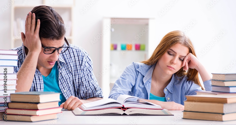 Pair of students studying for university exams Pair of students studying for university exams