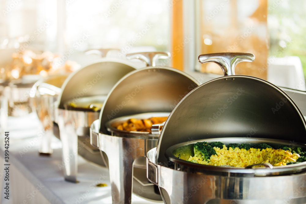 Elegant chafing dishes and food warmers with various meals served for  catering reception in hotel or restaurant. Buffet served by the catering  service company. Appetizers in elegant serveware. Photos | Adobe Stock