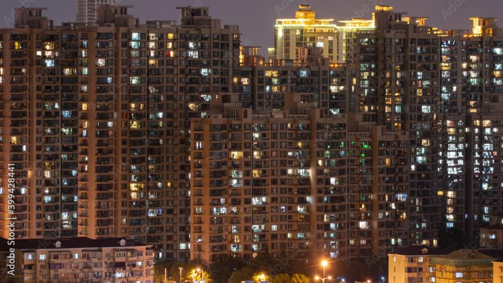 Day to night transition timelapse of many Shanghai buildings. Chinese crowded city apartments with lights at midnight. Fast paced modern Asian night-scape time lapse in urban metropolis. Day to night transition timelapse of many Shanghai buildings. Chinese crowded city apartments with lights at midnight. Fast paced modern Asian night-scape time lapse in urban metropolis.