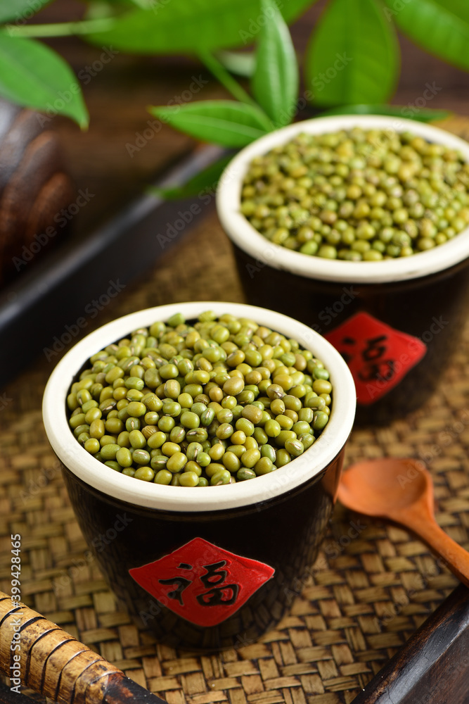 Mung beans on the background of retro Chinese style.The Chinese meaning in the picture is happiness Mung beans on the background of retro Chinese style.The Chinese meaning in the picture is happiness