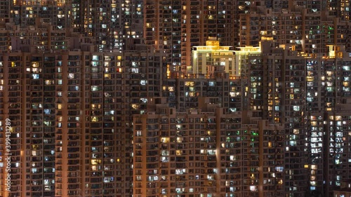 Day to night transition timelapse of many Shanghai residential buildings. Chinese crowded city apartments with lights at midnight. Fast paced modern Asian night-scape time lapse in urban metropolis.