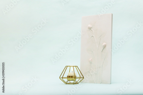 Botanical bas-relief wildflowers and candle for wall art. 3D Flower plaster decor. Stylish and modern interior of room.