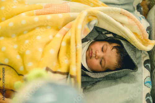 Baby sleeping, pretty baby born, bebe durmuendo en cuna, Adorable little baby portrait. Cute baby girl indoor. 6 month child smiling. photo