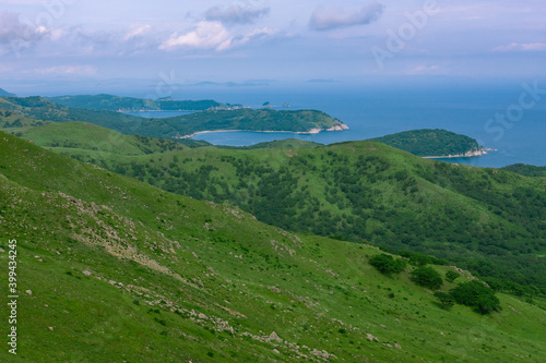 Rocks on top of a hill, background summer coastline of Astafiev Bay, Primorsky Krai, Russia.