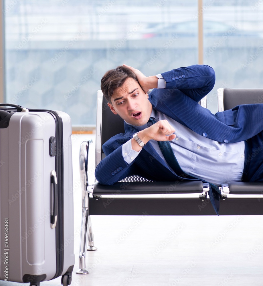 Businessman waiting at the airport for his plane in business cla Businessman waiting at the airport for his plane in business cla