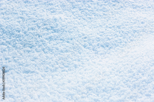 snow in sunny weather . fresh snow background. high angle view of snow texture Natural winter background with snow drifts and falling snow. 
