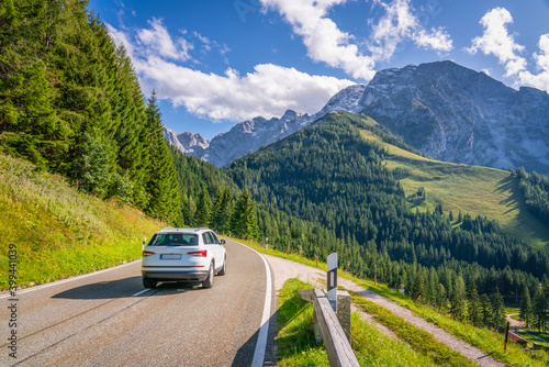 Car in motion at Rossfeldpanoramastrasse with Alps in the background. Bavaria. Germany 
