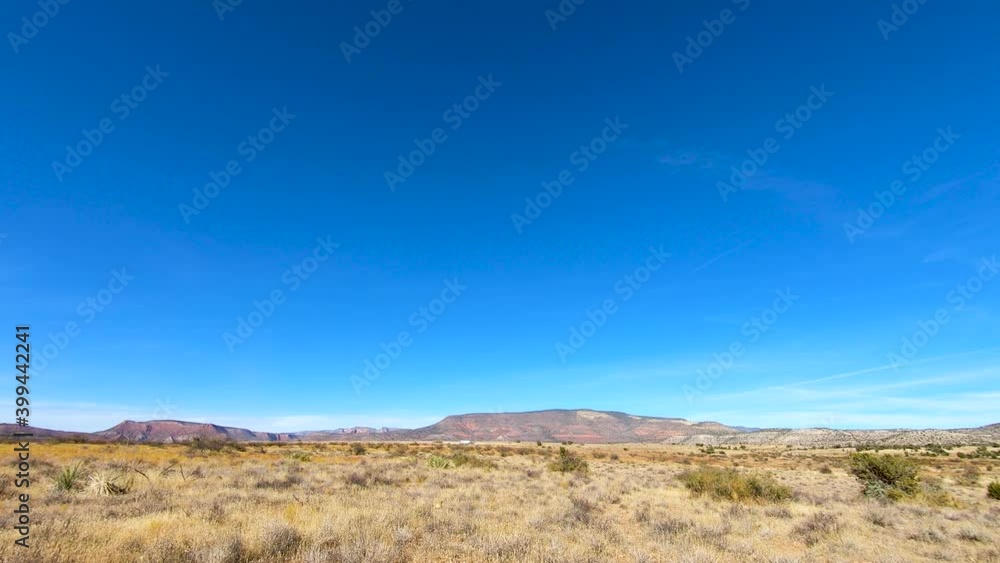 Time-Lapse, clouds, and dust pass over open high desert as a drone drops in for a look. . Time-Lapse, clouds, and dust pass over open high desert as a drone drops in for a look. .