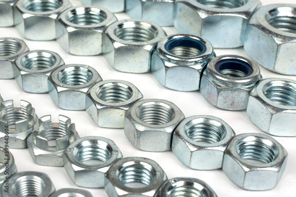 metal nuts of different sizes in several lines metal nuts of different sizes in several lines