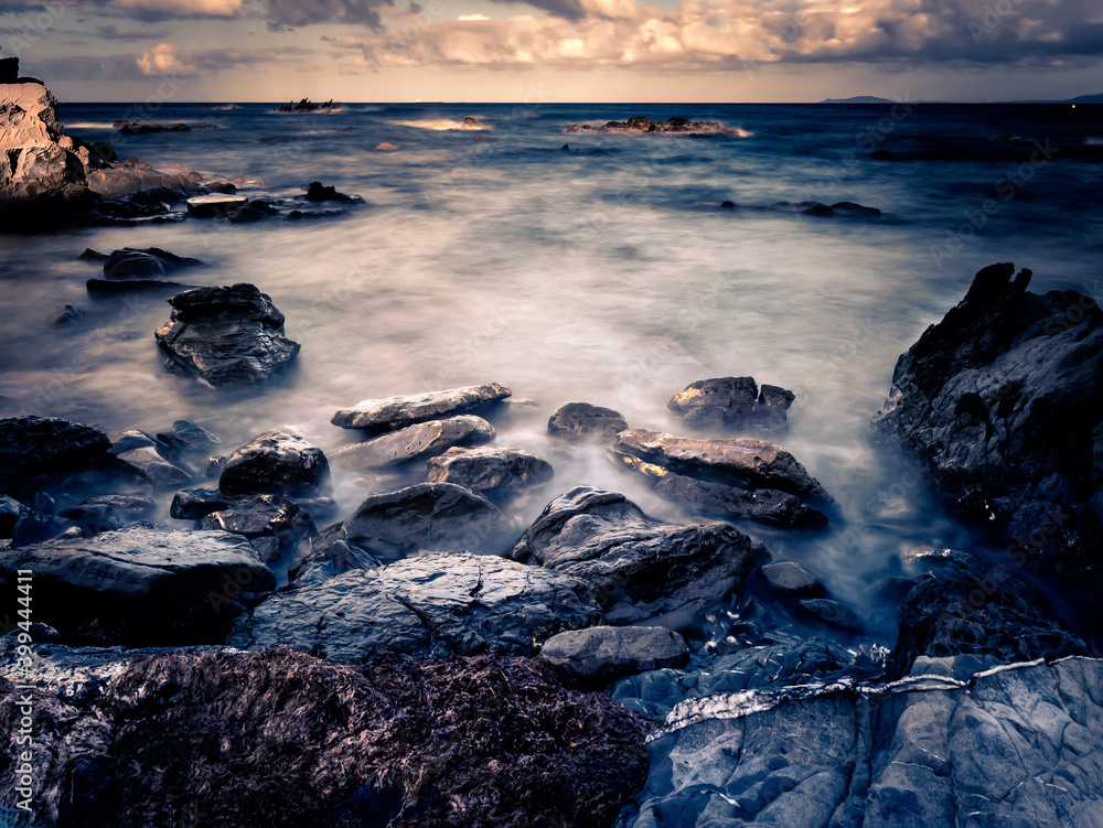 Rocky coastline with motion blurred ocean in the strait of Gibraltar