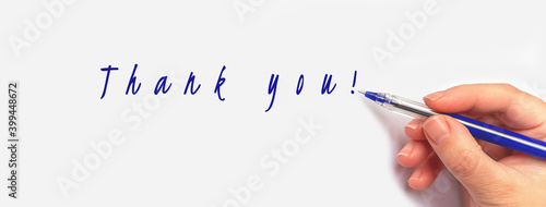 Large banner with caucasian hand writing blue pen on light background thank you text. International thank you day concept.  photo
