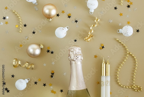 Happy new year 2021 with champagne and  decorations in gold colors on gold ba...