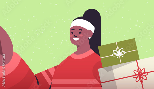 happy african american woman with gifts holding camera and taking selfie new year christmas holidays celebration concept horizontal portrait vector illustration