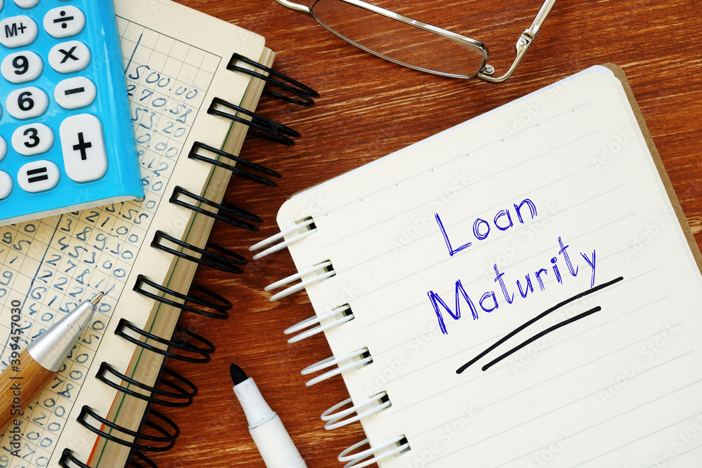 Loan Maturity phrase on the piece of paper. Loan Maturity phrase on the piece of paper.
