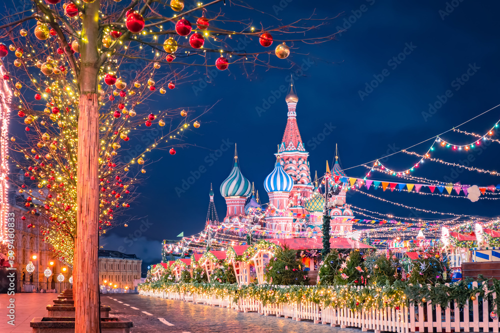 Christmas market in Moscow. New year celebrations in Russia. Christmas decorations on red square. St. Basil Cathedral on the background of festive decorations. New year in the capital of Russia. - obrazy, fototapety, plakaty 