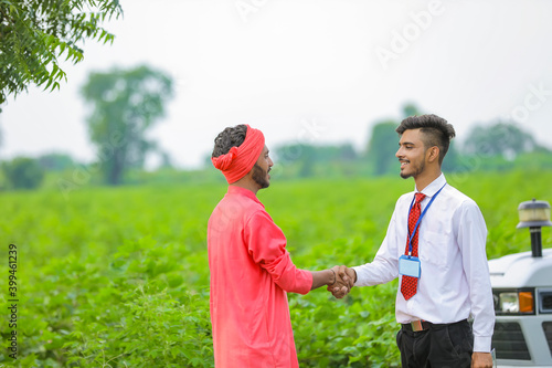 Banker and farmer negotiating bank agriculture loan in field