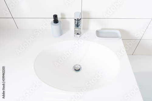 Modern bathroom at home. White stone table in bathroom and new mixer