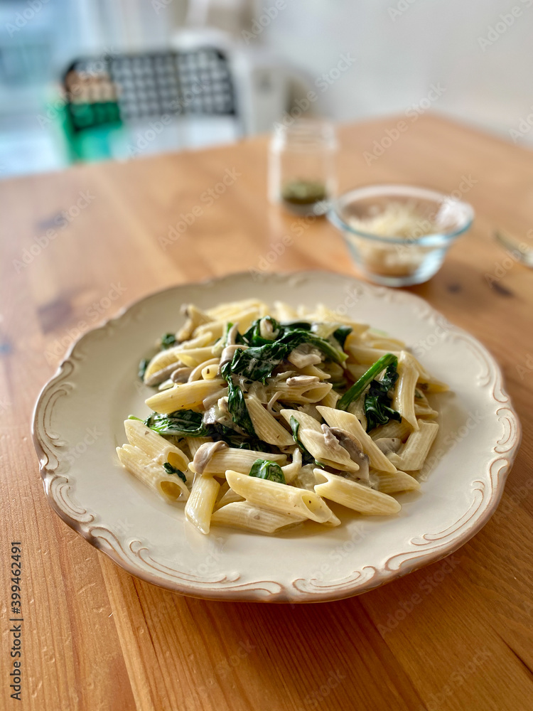 Penne Pasta with Baby Spinach and Truffle Cream Sauce. Served with Parmesan Cheese. Penne Pasta with Baby Spinach and Truffle Cream Sauce. Served with Parmesan Cheese.