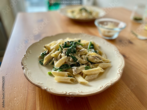 Penne Pasta with Baby Spinach and Truffle Cream Sauce. Served with Parmesan Cheese.