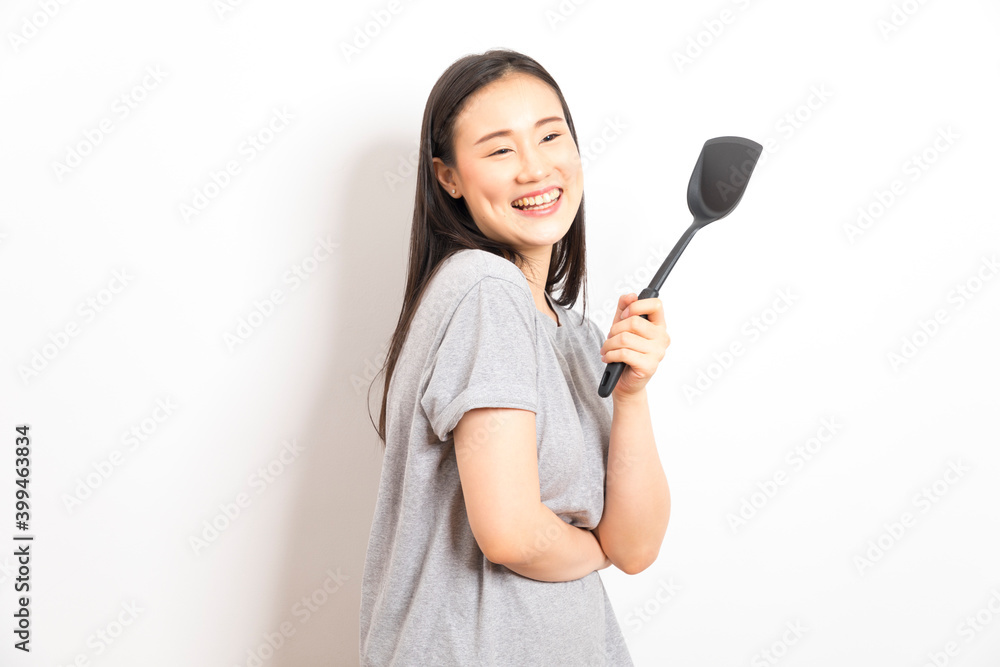 Asian woman holding ladle ready for cooking isolated on white background. Asian woman holding ladle ready for cooking isolated on white background.