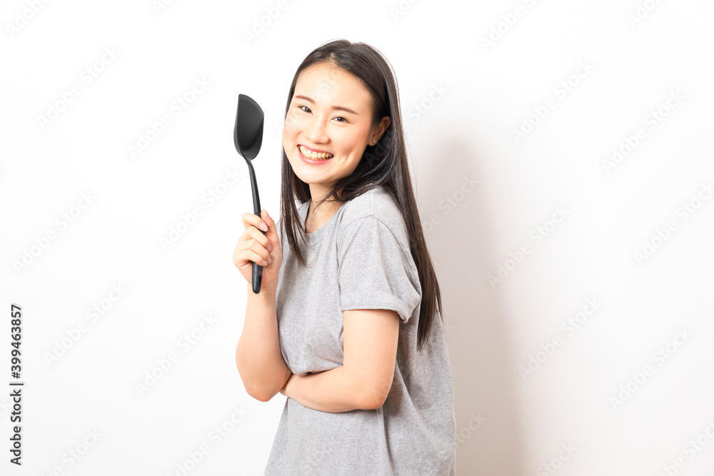 Asian woman holding ladle ready for cooking isolated on white background. Asian woman holding ladle ready for cooking isolated on white background.