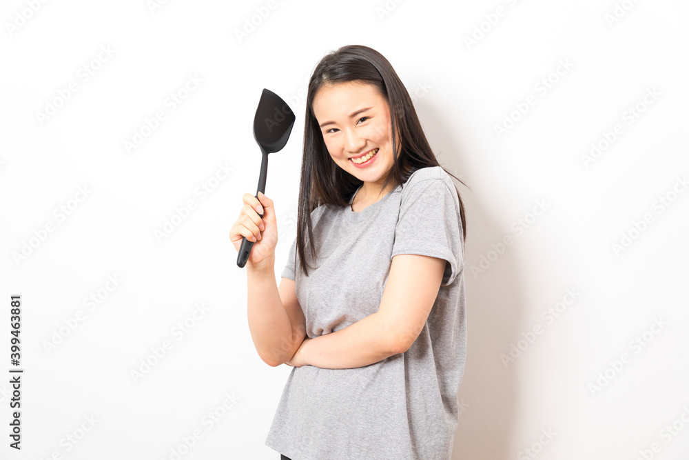 Asian woman holding ladle ready for cooking isolated on white background. Asian woman holding ladle ready for cooking isolated on white background.