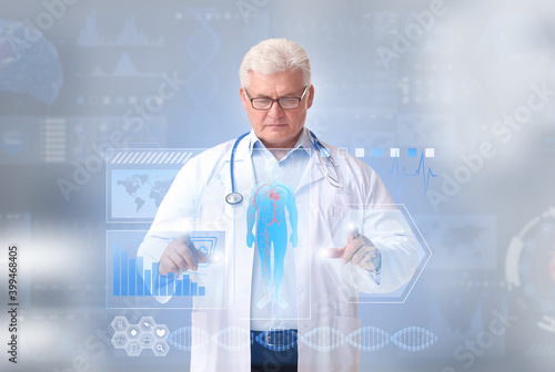 Mature male doctor using vi...