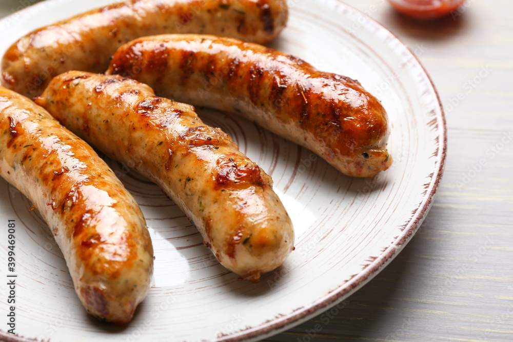 Plate with delicious grilled sausages and vegetables on table, closeup Plate with delicious grilled sausages and vegetables on table, closeup