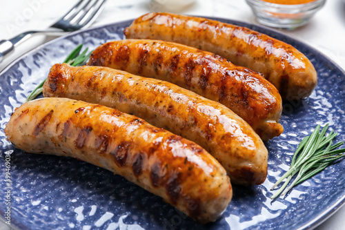 Plate with delicious grilled sausages, closeup