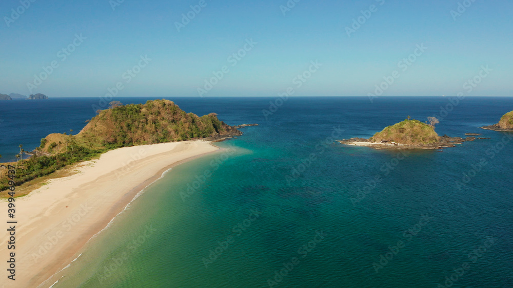 Tropical island with sandy beach, aerial view. Nacpan, El Nido, Palawan, Philippine Islands. Seascape with tropical beach and islands. Summer and travel vacation concept Tropical island with sandy beach, aerial view. Nacpan, El Nido, Palawan, Philippine Islands. Seascape with tropical beach and islands. Summer and travel vacation concept