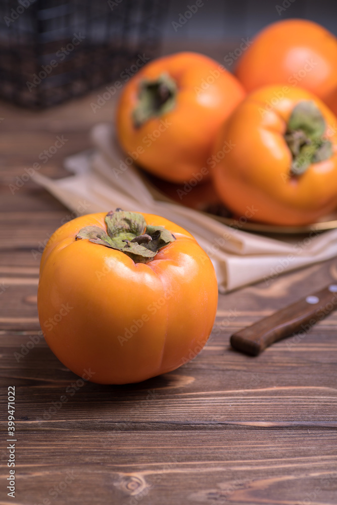 Delicious fresh persimmon fruit on wooden table. Delicious fresh persimmon fruit on wooden table.