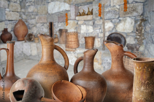 A set of traditional Georgian wine jugs and clay cups in marani (cellar for storing wine in special pitchers)