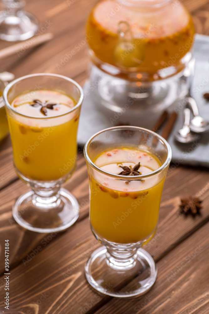 Beautiful glass teapot with orange sea buckthorn tea. Hot winter drinks, Beautiful glass teapot with orange sea buckthorn tea. Hot winter drinks,