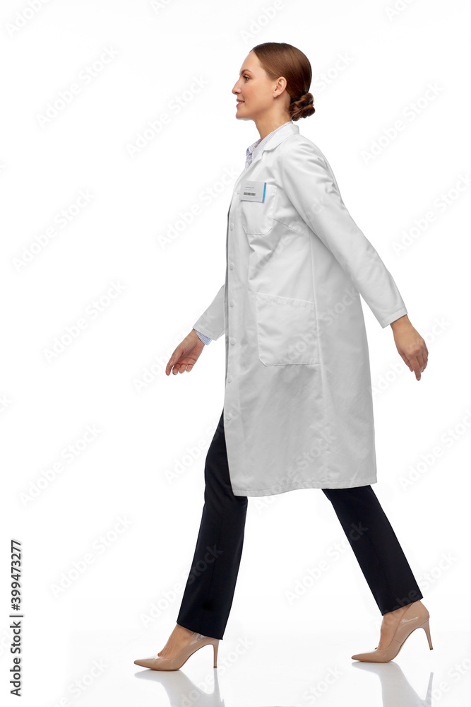 medicine, profession and healthcare concept - happy smiling female doctor or scientist in white coat walking medicine, profession and healthcare concept - happy smiling female doctor or scientist in white coat walking