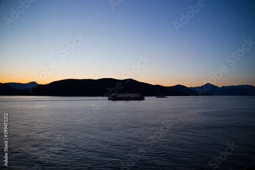 two ferries passing on Howe Sound with Bowen Island in the distance at sunset or twilight
