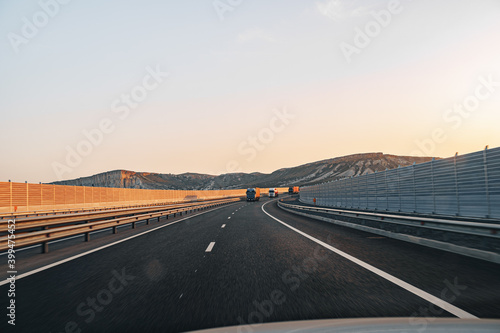 Empty highway at dawn, view from driver's perspective