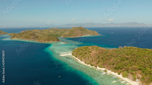 aerial view tropical islands with blue lagoon  coral reef and sandy beach. Palawan  Philippines. Islands of the Malayan archipelago with turquoise lagoons.